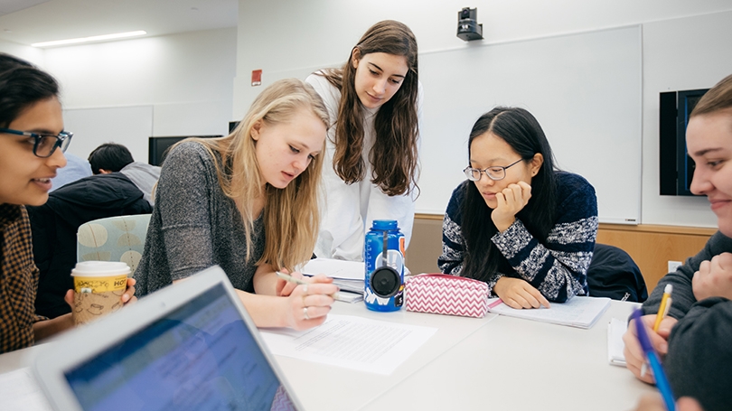 students gathered around a classroom table