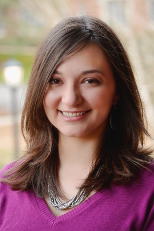 Alyssa's headshot. She is a white woman with shoulder length brown hair.